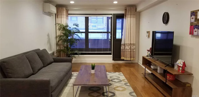 Spacious 2BR with large outdoor patio/covered porch. Private washer/dryer in the unit.  A desirable co-op with low maintenance and guaranteed indoor parking. Close to LIRR and Town. It is one flight up from lobby floor. New hardwood floor, hi-hats lightings and ACs