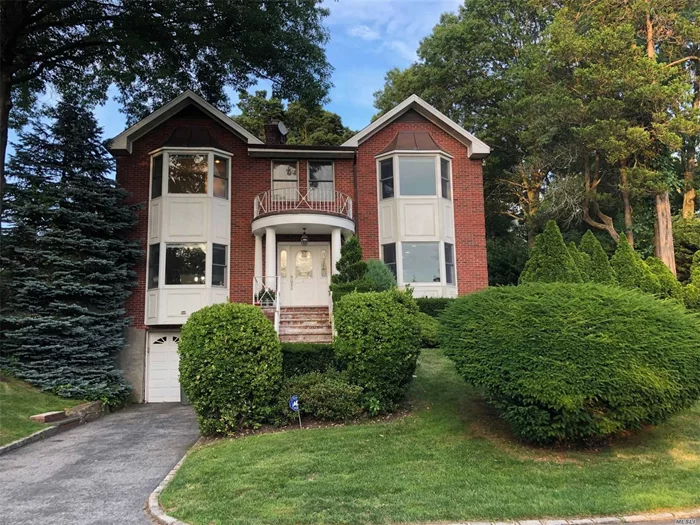 Lovely Brick Colonial Situated on a Corner Lot. Formal Living Room w/Fpl, Formal Dining Room w/Fpl, Updated Eat- in- Kitchen, 5 Bedrooms: 2 Master Bedroom Suites (1 on First Floor), 3 Full and 1 Half Bathrooms, Hardwood Floors Throughout. Lots of Storage Space and Laundry on Lower Level. 1-2 Car Attached Garage. Patio and Screened Porch, Beautiful Landscaping (included). Close Proximity to Town and LIRR. Manhasset Schools!