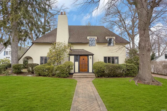 VIRTUAL TOUR LINK: https://jumpvisualtours.com/u/338296 OR CALL THE LEVIN TEAM FOR GUIDED SLIDE SHOW CALL 516-714-2633 FOR GUIDED SLIDE SHOW Architecturally significant Tudor w/soaring 20ft+ ceilings, South facing windows filled w/sunlight! Living room w/ fireplace, updated kitchen & newly renovated baths and walk out basement. Flexible layout with master on main floor. Oversize flat yard in lovely neighborhood, walking distance to parks, stores, bus & worship. Smart home has system to control temperature, lights & locks remotely. House has generator. Taxes have been successfully grieved and will reduce 16% (not reflected above)