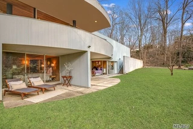 This Masterpiece of Modernist Architecture was an Architectural Record HOUSE OF THE YEAR & designed as a piece of art by renowned Architectural Firm of Gwathmey & Henderson. The pavilion-like quality of the fabulous living rm/dining rm space has sweeping views of the outdoors w/floor-to-ceiling walls of glass & a circular terrace emphasizing the dramatic design of the home into the landscape. Enjoy the separate Mooring lot on Huntington Harbor, close to Huntington&rsquo;s exciting food & art scene.