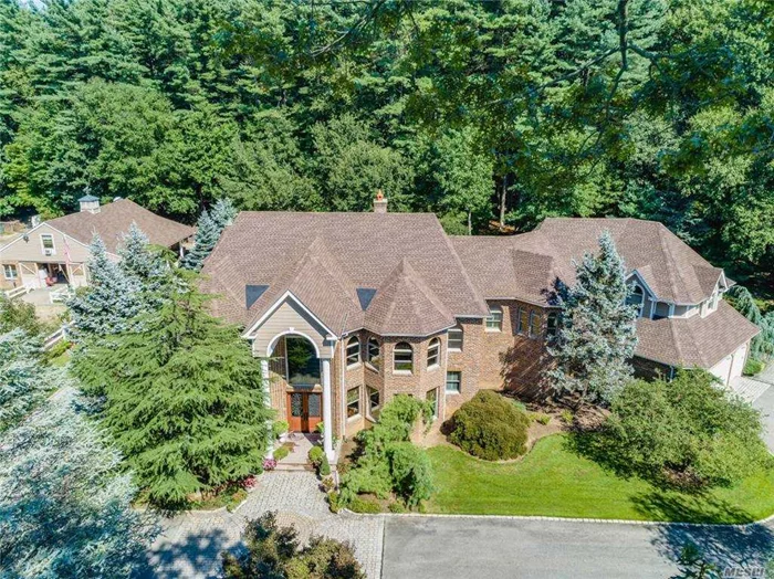 A beautiful extremely private brick colonial in the Village of Laurel Hollow. The main residence features 4 bedrooms and 5 baths, a large eat-in-kitchen w/high end appliances, island, and walk-in pantry. In addition, a family room (could be 1st floor bedroom), custom office, formal dining room, and a sitting area w/ gas fireplace. The second level offers an oversized master suite with its own sitting room and 3 walk in closet, two bedrooms w/ a Jack and Jill bathroom, and a 4th bedroom with a full bath. The home is outfitted with custom window treatments and pristine interior design. The property is over five acres w/ a 7-stall custom barn w/ heat, electric, water, and 2nd level caretaker&rsquo;s quarters (one-bedroom apartment w/ full kitchen and laundry). There is also a tack room, wash bay, sand arena, and paddocks. An entrance on the property leads directly to 30 acres of trails. there are deeded riding rights. The backyard includes an expansive stone patio and a full kitchen.