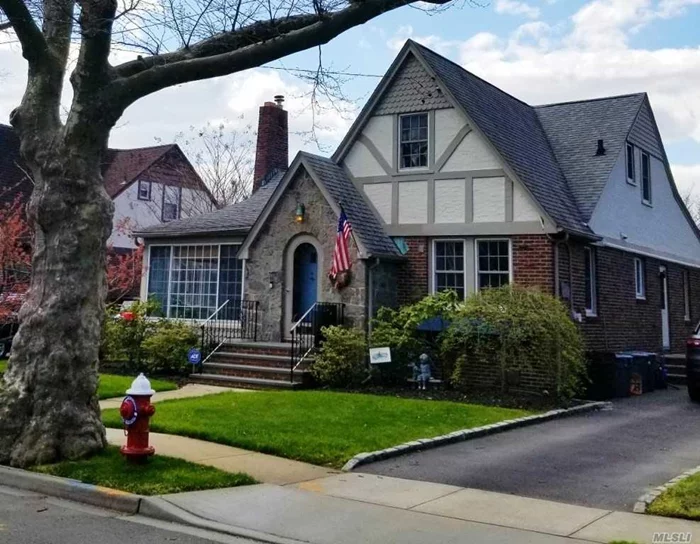 Beautiful home with several updates situated on a quiet tree-lined street. Upon entering, relax in the sun room off the front of the house. Enjoy the open layout great for entertaining. Formal LR w/WB FP flowing nicely into the Dining Room and Updated EIK w/SS Appliances. HW flooring throughout first floor, 2Bedrooms or one room can be a den space. 2bds on 2nd fl w/half bth & Storage Space. Large Partially Fin bsmt w/high ceilings. Other features include: updated electric, 6-zone In-Grnd Sprinklers, Updated heating Sys, Tankless HW heater, 3 Ductless A/C units, water filtration system, 1car det garage, large shed, deck & Immaculate yard/landscaping. Close proximity to LIRR, schools, shops & restaurants.