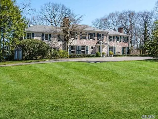 Long Private driveway leads to this 6 bedroom Whitewashed Brick Colonial with Slate Roof, Pool and Tennis court situated on 6 prime Matinecock acres at top of the hill. Panoramic Hilltop Views.