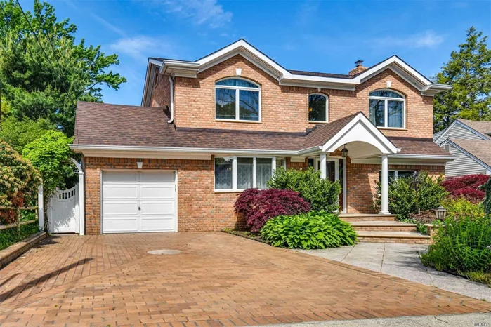 Mature Japanese maples adorn this beautifully updated 5-bedroom 2 bath brick home. Recessed lighting, decorative moldings, and granite floors with radiant heat welcome you into the open LR/DR area. The wood burning FP has been updated with new doors and bleached pine surround. Cherry wood cabinets and granite countertops in the kitchen with a pantry on the main floor. One of the two main floor bedrooms is currently being used as a laundry room but can be easily converted back to a bedroom. Bedrooms on the main floor are original hardwood. Bannister and stairs are oak, as are floors in the 3 upstairs bedrooms. 2 panel solid wood doors throughout. Both bathrooms updated in 2017 with Kohler fixtures. Sliding doors off the kitchen lead to granite steps / paver patio and the flat backyard, complete with in-ground sprinklers. The partially finished basement provides plenty of closets and storage.  The electrical system has been upgraded to 200 amp and is set up for a generator.