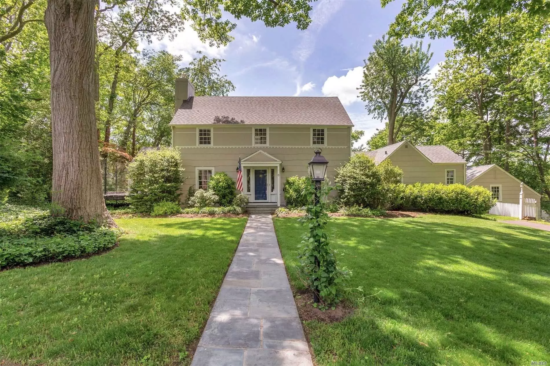 Port Washington Estates classic center hall colonial on 106X170 property with updated EIK that opens to den and an office that has an outside entrance and full bath. Office can serve as bedroom, as well. Screened in porch off LR w/FP. 3 bedrooms and full bath on 2nd floor, walk up attic. 2 zone gas heat, CAC on 2nd floor, hardwood floors throughout, beach and mooring rights . Convenient to town and train