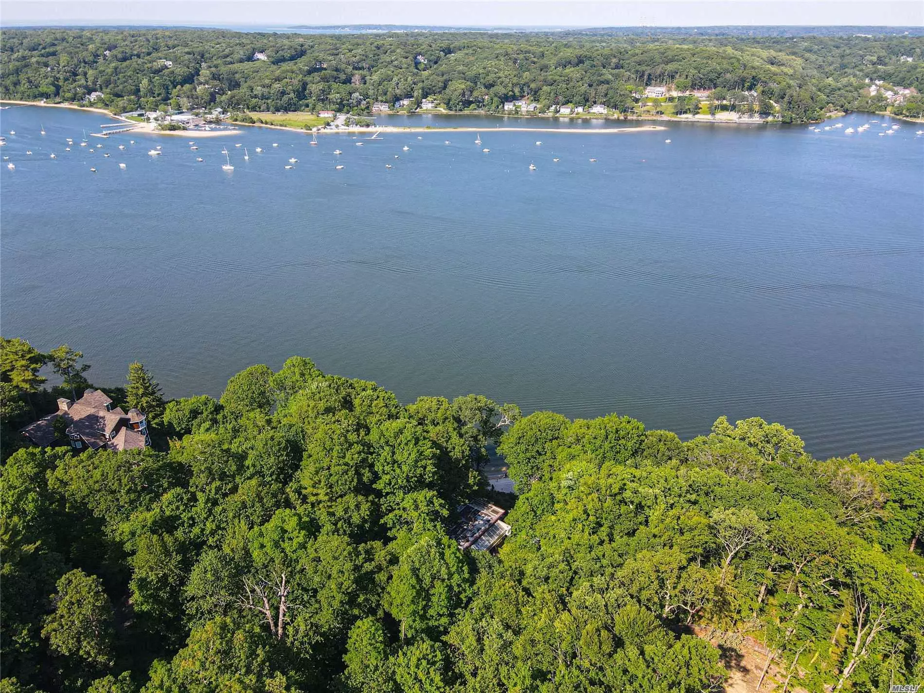 Welcome to this direct waterfront location with wonderful views overlooking Cold Spring Harbor and Long Island Sound. On approximately 3.56 acres. This home was an inspired design of Frank Lloyd Wright renovated in 2008 with views day and night. This is residence features your own white sandy private and secluded beach. This home offers 2 fireplaces, European kitchen with Corian countertops, GE double ovens, Frigidaire stove, and Sub-Zero refrigerator. Large Living room and dining area with fireplace have full views of Cold Spring Harbor. Lower level of home has walkout with fireplace. Featuring 5-stage filtration on drinking water, large working greenhouse, and whole house generator. Too much to list! A must see!