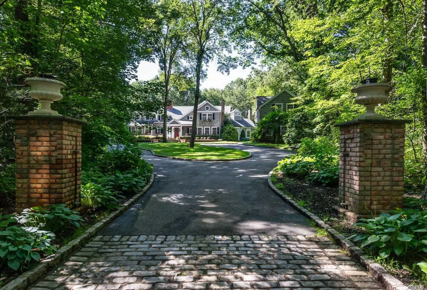 Hampton&rsquo;s shingle-style residence located 45 minutes from Manhattan on 2.26 acres privately set back from road. Large principal rooms designed for entertaining: gourmet kitchen opening into inviting great room with fireplace, living room w/ fireplace and French doors accessing a beautiful covered porch, library, guest room with ensuite bath, incredible master bedroom, with marble bathroom and roof deck, additional 3 bedrooms 2 baths, lower lever has wine cellar, playroom, full bath and exercise room. Professionally landscaped with classic inground pool and patios. Separate 3-car garage with stairs to large loft space. CSH SD# 2 - Laurel Hollow Village Beach and Mooring Rights 1.3miles down the road .