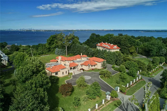 Video Tour A Must See! Majestic breathtaking vistas from this magnificent 6 bedroom secluded waterfront estate. Once in a lifetime does an opportunity so unique come on market. Glamorous entry foyer with soaring ceilings, grand open layout throughout, expansive living room with an intricate marble fplc, formal dining room with water views, gourmet eat-in-kitchen with a wall of windows overlooking the lush grounds, Mater en suite located on the first floor with double walk in closets and two separate bathrooms and private office, in home elevator, movie theatre, gaming room, billiards room, and indoor pool. The property has a separate cottage with an extra 3 car garage, ideal for guests.