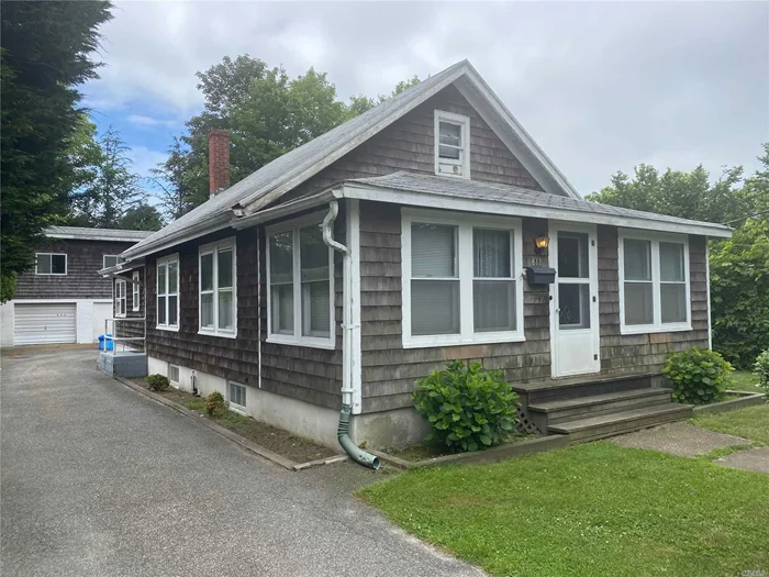 Great location close to beach! Home features Large kitchen, dining room, large living room. Enclosed front porch. Can be 2 bedrooms upstairs. Full basement. Detached 2 car garage with apartment on top: Living room, kitchen, bedroom, bath.
