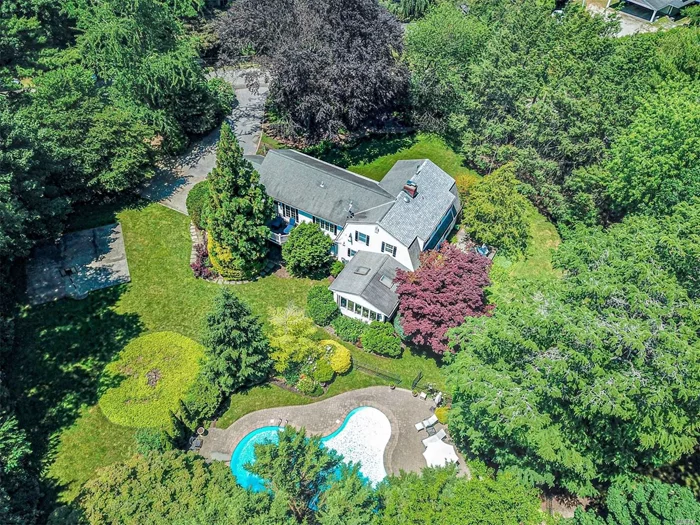 Incredible one-acre park like property with towering trees, sparkling inground pool with waterfall, hot-tub and privacy affords a country lifestyle free from traffics intrusion all within a stone&rsquo;s throw to a private beach.