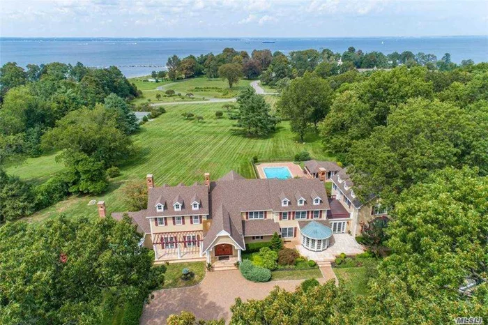 Enjoy Panoramic Sunsets Over The Li Sound From This Fabulous 8 acre Waterfront Estate Complete W/Pool, Tennis Ct, and 3-Car Garage W/Guest Quarters. This Custom Designed House Is Classically Tailored & Redefines Traditional Design. Sweeping Lawns, Desirable Location, Top Quality Construction. Guest House, Tennis, Pool and Outdoor Kitchen with Patio. Beach and Mooring Rights. Assoc. Dues.