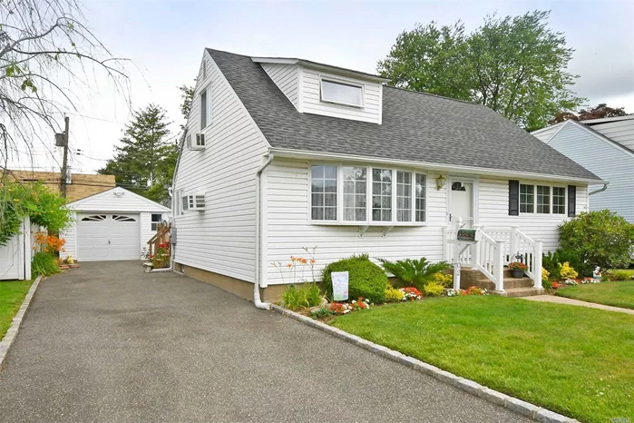 Wonderful Cape Located In North Hicksville! Updated Kitchen w/ Gas Cooking, Granite Counters. Gas Heating & Dryer, Partial Finished Basement, 1 1/2 Car Garage, Private Fenced Yard, Beautiful Curb Appeal!