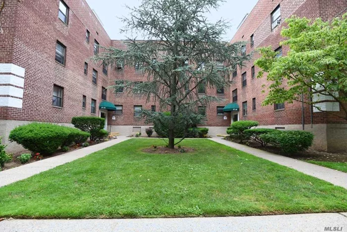 Beautiful first floor Junior 4 corner unit with hardwood floors, kitchen and bath updated 2012, breakfast bar, large bedroom, office/small bedroom with pocket door, laundry on site, community pool w/ picnic area, garage wait list, close to shopping, less than 1 mile to Bayside LIRR. No alternate street parking rules.Heat & water incl in Maintenance. Pets OK with Board Approval.