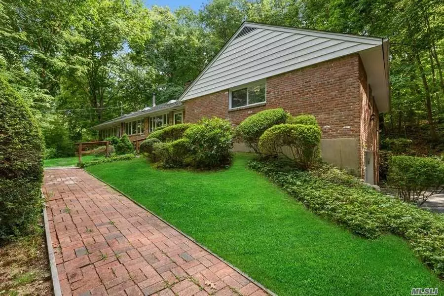 Retreat to your own private sanctuary on 2 verdant acres in Oyster Bay Cove. This charming ranch is located on a quiet, tree-lined street and features a formal living room with a fireplace, Eat-in-kitchen, and a great room overlooking the lush property. Freshly painted, this 3-bedroom and 3-bath home features a finished lower level with a brick fireplace and abundant storage space. This lovely home boasts hardwood floors, a 2-car garage, a patio surrounded by specimen trees and mature plantings, Laurel Cove Road Beach Association and low taxes.