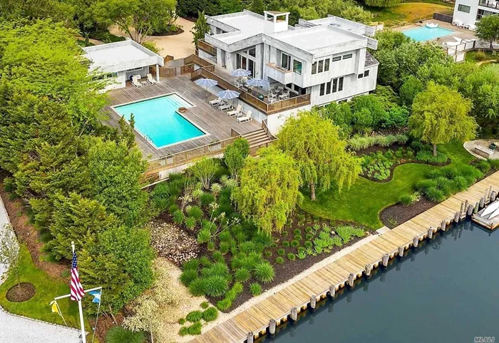 1.45 acres, renovated 5000+ sq. ft. waterfront Contemporary in Westhampton Beach. Beautifully Landscaped, canal-front with a waterside pool & patio, expansive mahogany decks & N/S Har-Tru Tennis Court. 165&rsquo; of bulk-heading and a floating dock. Includes pool house cabana w/ bath. 2 story Living Room, Family Rm, Beautiful Wine cellar, cedar closet, 2 car garage & Koi pond. Very near Town & Beach.