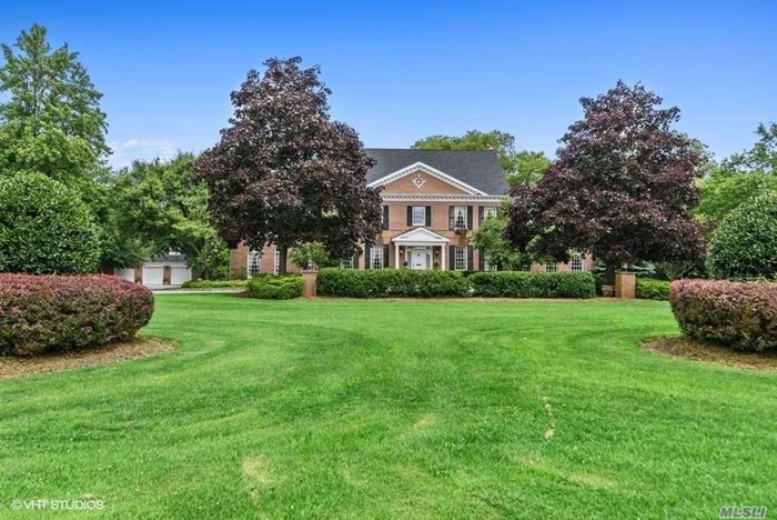 Stately Brick Georgian Colonial on 2.3 acres in prestigious O-Conee Association. Custom built in 1991, this elegant home features features marble and hardwood floors, floor to ceiling Palladium windows, custom wood panelings and mouldings, 12-foot ceilings, living room with wet bar, home office, billiards room, 28x23 ft. great room, 2 fireplaces, more. 2 slate and brick patios overlook its pristine private property featuring 1000 sq. ft. 3-car garage with loft area, raised garden beds, golf chipping green, perennial gardens. Home Owners Association amenities include docking at 2 private marinas, private bay front beach, security. Simply gorgeous home!!