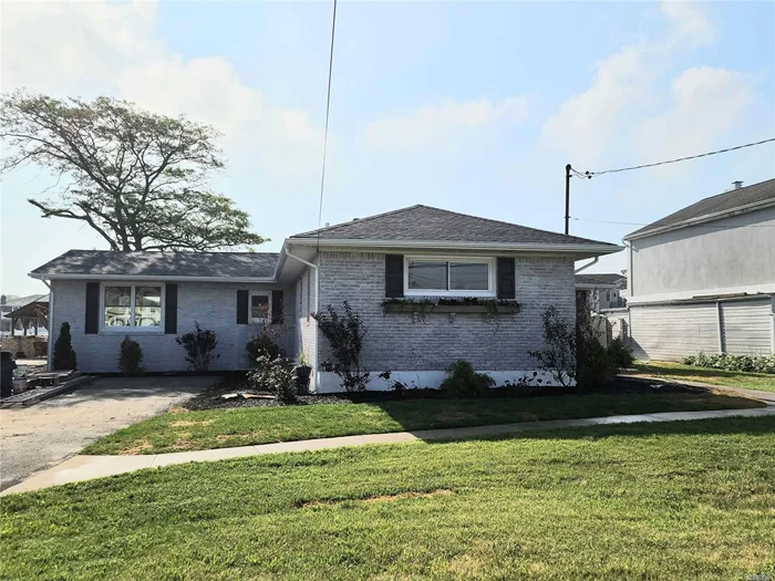 Incredible brick and vinyl ranch completely remodeled with new brick work, vinyl, kitchen, 3 new bathrooms, new flooring, CAC, bulkhead in great shape, exceptional water frontage and tremendously spacious rooms. Living room with fireplace, den facing the water and many upgrades to make for a custom oriented renovation.