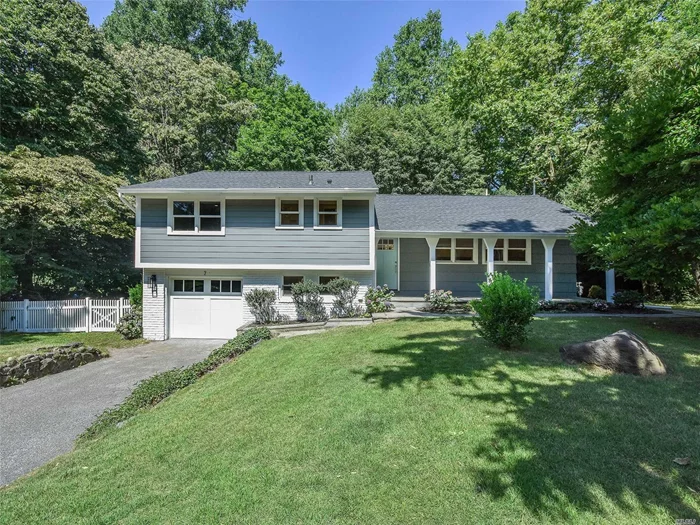 Fully renovated from top to bottom, spacious and sunbathed Split Level home on a quiet tree-lined street. This pie-shaped 1/3 acre property welcomes you in via a covered front porch. Entryway leads to stunning hardwood oak floors that flow throughout an open floor plan with quartz and stainless steel gourmet kitchen with bar seating, open dining room and living room with wood burning fireplace and oversized Andersen windows. Upper level features a master suite with marble bath and two additional bedrooms plus hall bath. Finished lower level with sliders to yard, new powder room and laundry room. Finished basement with egress window and room for rec room or home office. The backyard is ultra private and features surrounding woods.