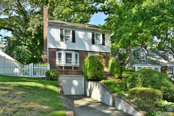 Charming colonial beauty in the heart of Holliswood. On the main level one can find the gorgeous living room with wood burning fire place, beside it is the formal dining room and on the same level you may find the eat in Kitchen with Quartz counter tops and stainless steel appliances, and the powder room. Upstairs there are 3 large bedrooms and a full bath as well as an office area. The lower level has a family room, Laundry area and utilities. From this level you may enter the garage door. This colonial style house sits on a 52X107.5 lot and with windows that were recently updated. Additional amenities include an attached garage, central A/C, updated plumbing, a main line water filter purification system and security system. The backyard has an oversized deck ideal for family gatherings and entertainment. This home is located in the middle of Holliswood area and is near schools, shopping, and transportation. A must see!