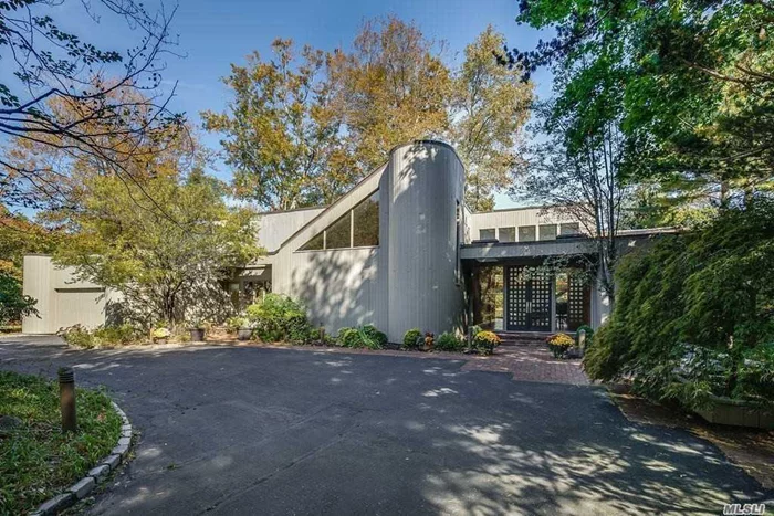 Beautiful Contemporary with a Circular Driveway. Walls of glass overlook tranquil pond from almost every inch of this custom home! Open floor plan leads to a grand entry surrounded by formal entertaining rooms and Main floor Master Bdrm Wing/his-hers bathroom/Walk-in designer Closet. Second Floor is a children&rsquo;s paradise! Walls of glass, wrap around decks, gunite pool/hot tub, & more make this offering..unparalleled! (See attached for floor plan ) No show weekend.