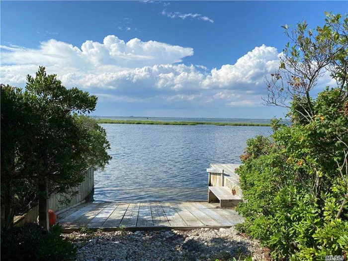 Boater&rsquo;s Dream with 50&rsquo; of bulkhead and a deck to relax! Access to the Ocean Beach for great surfing, swimming, kite surfing or just lounging in the sun! After your swim in the Bay return home and enjoy a refreshing outside shower. Decks are on all sides of this house so you never miss a sunrise or sunset. Charming winding path of gardens leads past the garage and private driveway. There&rsquo;s even a heated garage for working on winter projects. A cozy boat-like feel inside this classic beach home is what gives it the enchanted ambiance! Views of the Great South Bay, NYC and the Ocean tell you this is a once in a lifetime opportunity to be somewhere very special!