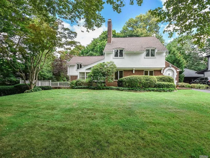 Charming 4-Bedroom, 3-Bath English Colonial set on flat, shy half acre. Close to town and LIRR