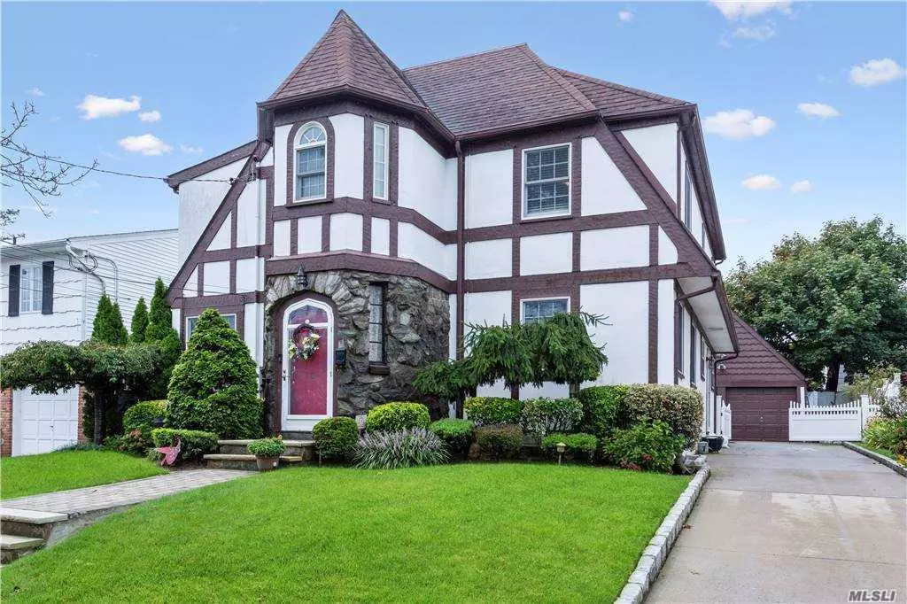 Exceptional Four Bedroom Tudor Home in the heart of South Lynbrook SD#20. This charming home features original detailing - Stained Glass Windows, Red Oak Plank Peg Wood Floors, Spacious living room with Wood Burning Fireplace, Formal Dining Room, Gourmet EIK Granite counter top, CAC, Half Bath, Bright Family Room w/Sky Lights and access to patio w/new pavers on main floor. Master Bedroom Suite with Master Bath Jacuzzi tub & separate shower, full bath and two additional bedrooms on second floor. Bedroom/office and extra storage on the third floor. Finished basement, new wall to wall carpet, family room, office, laundry room and ample closets throughout, many new utilities and so much more! Total Taxes $17, 169 includes Village Tax and excludes STAR.