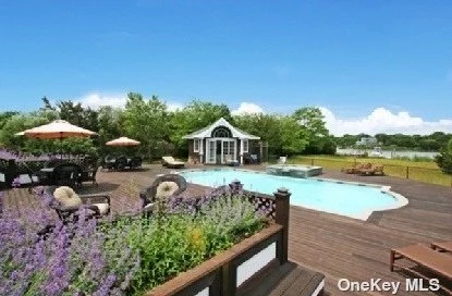 CUSTOM POST MODERN WITH BOAT DOCK! WESTHAMPTON, WATERFRONT 1.5 WATERFRONT ACRES 8000 SQ.FT. Home, Two story high grand living room with fireplace, Grand Family Room and Kitchen combined, Huge Master bedroom suite with Sitting-Room, fireplace and balcony overlooking the bay, 5 additional guestrooms with bath. Beautiful Water Views with Deep Water Boat Dock and a 3 Car garage. High End Waterfront Community waterfront community. Exclusive $4, 599, 000