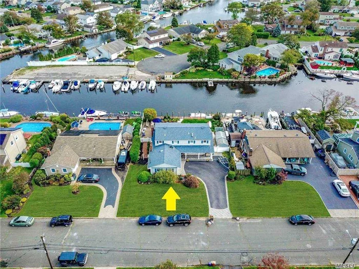 Boaters & entertainers delight!! Not to be missed gorgeous expanded farm ranch in the coveted Crystal Harbor community. This stunning home sits on a private canal w/85 ft navy bulkhead w/water & elec. This home boasts large first flr master bdrm w/waterviews & cedar lined WIC. 5 Bdrm 3 full bths, EIK w/rad heat, granite counters, custom cabinets w/under cab lighting, SS apps, beautiful wd floors, 4 skylights, Florida room w/rad heat & built-in cabinetry/butlers pantry, slider to pavered patio. Second floor has 3/4 large bdrms and/or home office. Anderson windows, rec lighting, large mudrm and plenty of storage. Walk to Public Golf Course. Do not miss seeing this stunning home! Flood zone X - flood insurance not required! 2 Zone of AC and 5 Zone Heat. ** excluded - fig tree, dr fixture, garagetec system, gun safe***