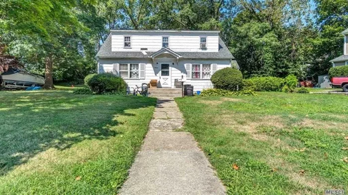 This cozy, legal Two-Family home is just steps away from the LIRR on the North Shore of Long Island.  Separate entrance doors to each unit. Separate gas and electric meters for each unit. Recent updates include new sewer line, boiler, counter tops with a nine year old roof. The property sits on .65 Acre developable lot.