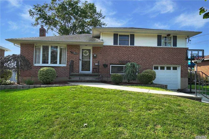 Spacious Side-By-Side 4 Level Brick Split Located Desirable Massapequa Park. Open Floor Plan Home Features Hardwood Flrs, Eik W/Ss, Slider to Tranquil Landscaped Private Backyard 79x117. Formal Dining Rm, Living Rm, Family Room w Fireplace, 1/2 Bath, Master W/Bath & Wic, 2 More Bedrooms, F/Bath, Central AC, In-Ground Sprinklers, 200 Amps, Attic, Basement, Garage, Natural Gas in Street, Close To Schools, Massapequa Preserve, Shopping, Restaurants & Transportation.