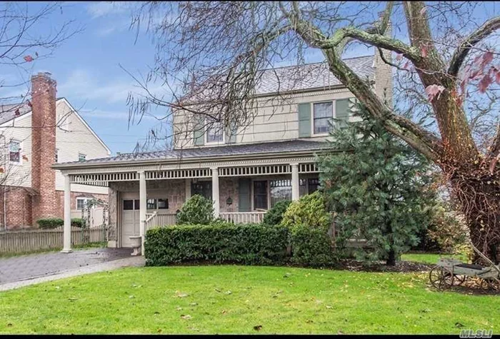 Beautiful corner property Colonial. Enjoy your covered front porch before entering into welcoming living room with working fireplace. Gleaming hardwood floors flow through the formal dining room leading into the huge back den with UV windows. Open the sliding doors and enjoy the new Cambridge paving stone patio and sun-filled fenced yard. An updated EIK with granite counter tops and a half bath finish off the main floor. Upstairs has 3 large bedrooms and a full bath; a finished basement with washer/dryer; 200 amp electric; CAC; garage and driveway for 4 cars and inground sprinklers make this house a must see. True pride in ownership. Lynbrook school district. One block from Marion Street Elementary School. Close to LIRR. Make this house your new home!