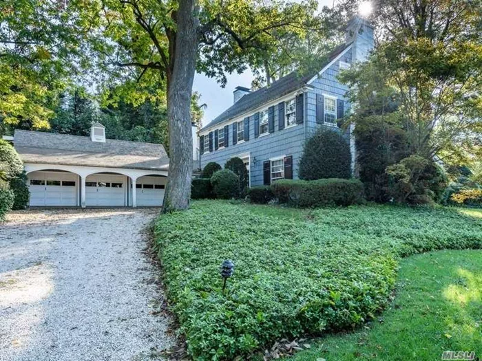 Overflowing w/charm and intriguing architectural details, this spacious farmhouse colonial awaits your vision and personal touch to continue to make it a warm and inviting home. Entry foyer greets you with wide plank pegged floors into an over-sized LR w/centerpiece stone fireplace. FDR, den, family room all with entrances to private backyard. Large kitchen w/adjoining mudroom/laundry and 3 car att garage. MBR w/bath & FP, full size walk up attic, back staircase to kitchen, all wood floors and detailed moldings. Located on an absolutely stunning tree lined and quiet street in Flower Hill, Port Washington. Taxes are being grieved.