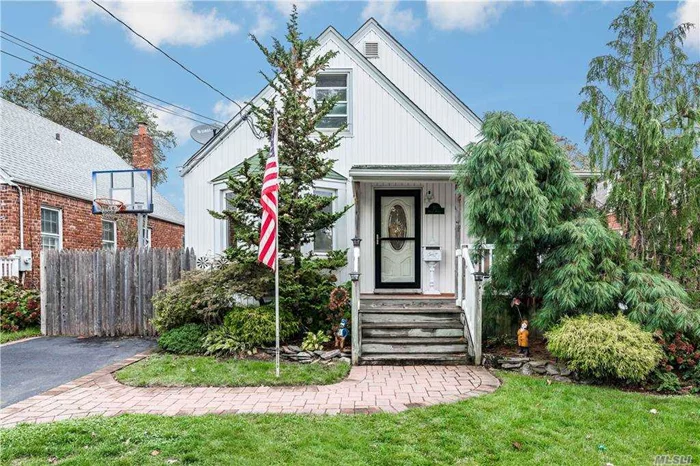 This 4 Bedroom, 2 Full Bath Cape Has It All. Updated Kitchen With Granite Counters & Stainless Steel Appliances. Updated Baths, Hardwood Floors, Full Basement-Partially Finished. Detached Garage, Charming Front Porch & Paver Patio In Yard For Entertaining. Close To LIRR, Shopping, Worship & Schools. Bus To Elementary, Middle & High School. Must See!