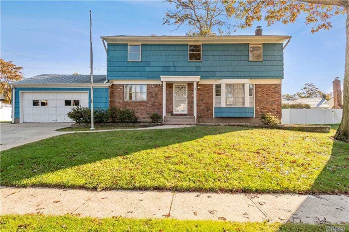 Syosset. This large colonial located on a tree-lined block in Syosset Woods features large rooms, over-sized yard, original hardwood floors throughout, full clean unfinished basement, garage. Needs TLC.
