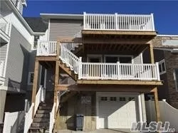 Beautiful raised 2 family house in West End on Beachside of Wide Block. Main floor apartment has front deck, open floorplan livingrm-diningArea-kitchen w/Breakfast bar, 2 bedrooms, small rm for home office & bath. 1 spot in garage which also has washer/dryer for this unit. CAC.