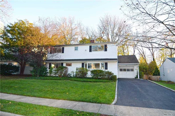 Reimagined and totally refreshed with a modern vibe. Fully expanded home with open floor plan flooded with light and overlooking private southern exposed back yard. Step inside to a welcoming and contemporary lifestyle! Entry Foyer, modern EIK opens to gathering Den with fireplace flowing into large open Dining/Living room - all featuring expansive windows and doors to private Deck. Full Bath and Bedroom/office on main level. 2nd level with 3 Bedrooms - large primary Bedroom plus 2 additional. Full Bath and laundry area. Attached garage with added storage shed in rear and attic storage.