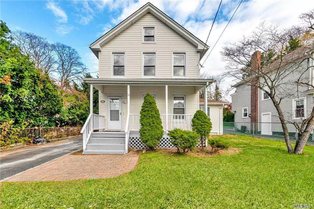 Gorgeous Classic Colonial in Glen Cove! Curb appeal at its best! Situated on a large 50 x 165 lot. Enjoy gardening and entertaining on the lush manicured lawn. An inviting front porch offer a casual outdoor space to relax. A private entrance foyer and hallway will lead you into a spacious room, perfect as a home office, guest bedroom or convenient first level bedroom. Beautiful walnut hardwood floors throughout. The large living room connects to a beautiful eat in kitchen with new custom light gray cabinets, maintenance free quartz countertops with a gorgeous waterfall, mosaic backsplash and stainless steel appliances. A convenient laundry rooms sits also on the first level along with a full bath, efficiency toilet, porcelain tiles and glass mosaic accents. 3 sizeable bedrooms on the second level with another brand new full bath with similar finishes. A bonus fully finished basement is below with recessed lighting and porcelain tiled floors. Near schools, parks, shopping restaurants.