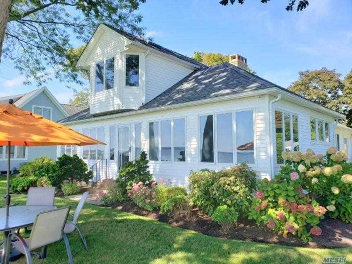 North Fork. Bay Front Charmer On The Beach at 15 Downs Boulevard in Jamesport. In coveted Fairhaven Private Community. Vintage cottage right on sandy bay beachfront. Sept and October $9000 per month, 2025 Winter Months at only $6900 per (2 month minimum). Summer 2024: July $28, 000. Lovely and well kept getaway full of olde time appeal. Spacious open plan with water views, new central air, new waterside patio and outdoor furniture, sleek kitchen, stainless appliances, wood floors. The main floor offers 3 Bedrooms to include a water view primary en-suite (bath with walk in shower), and 2 additional guest bedrooms with a hall bath. Second level has 2 bedrooms (one is water view), a loft with dormitory style beds, and another hall guest bath. Swim, kayak, bring a small boat to moor. Sunbathe out your back door, or meander just one lane over to town facilities with expansive beach, tennis courts, playground and marina with 4 public boat ramps. The Sweetest Summer Vacation On The Open Bay! RP# 24-0271