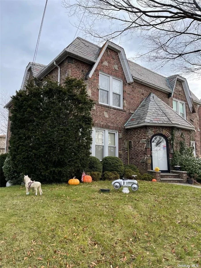 Sun drenched Semi Detached Solid Brick Tudor on a quiet St in Bayside. Det 2Car Garage w/2Car Driveway, Side and Spacious Back Yard can be fully used! Huge Living Rm/Big Formal Dining Rm, EIK, Porch, 3BRs & 2Bath Rm, Basement has a big Space & Bath Rm, Workshop & Sep outside door to the Sweet Patio/Back Yard.Hardwood Floors throughout, Close to Shopping/School/Bus & all major highways. Potential to little update or design for one&rsquo;s new dream home on this beautiful Tudor! R3X Zoning.