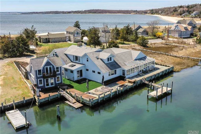 Located on private, Fisherman&rsquo;s beach, this ultra-luxurious waterfront property must be experienced to be believed. With 4600sf of living space, this home was extensively renovated in 2018 with sexy modern finishes, while maintaining it&rsquo;s North Fork charm.  5 oversized bedrooms, 6 baths, chefs kitchen, enormous living room with fireplace, open floor plan with panoramic views from nearly every room & 150ft of direct water frontage.  Enjoy sun soaked enclosed porch overlooking Haywaters Cove, bluestone patio w/ firepit and outdoor kitchen, extensive decking, 2 legal docks & access to one of the sandiest private bay beaches on the North Fork! In addition to incredible sweeping water-views, the sunsets are breathtaking! Property also includes a detached 725sf 2 story boathouse w/ tons of potential for guest quarters, gym, home office & more! A rare offering in a magical setting, this home is truly an entertainer&rsquo;s & boater&rsquo;s paradise. Excellent rental history & low flood ins premium