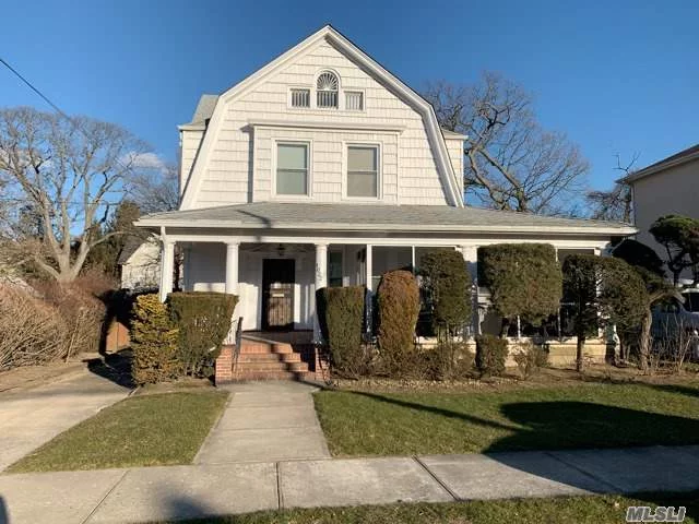 Great opportunity in Bayswater! Located on a quiet block, this beautiful 5 br (flex 7) Dutch Colonial home features 2 1/2 baths, EIK, Formal Dining Room, Breakfast nook, Den, Living Room, spacious screened front porch, walk-up attic, full unfinished basement with lots of storage and separate entrance, detached garage,  spacious backyard. Hardwood floors, high ceilings, lots of built-ins, 2018 Burner, Alarm system.  Ideal location: Near schools and shops, 5 minute walk to A train (Beach 25th) or 5 minute drive to LIRR (far Rockaway).