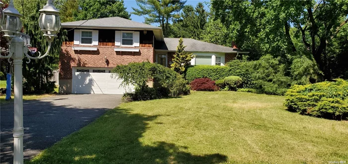 Beautiful Over Sized North Syosset Brick Split. It Features 3 Bedrooms,  3.5 Baths, Eat in Kitchen, Formal Dining Room, Large Living Room, Huge Den W/Sliding Door to Back Yard. Finished Basement,  Attached Garage. Updated Hardwood Floor, New Paint, Gas Heat, New Roof, Updated Electric. Close to Town, Train Station and School.