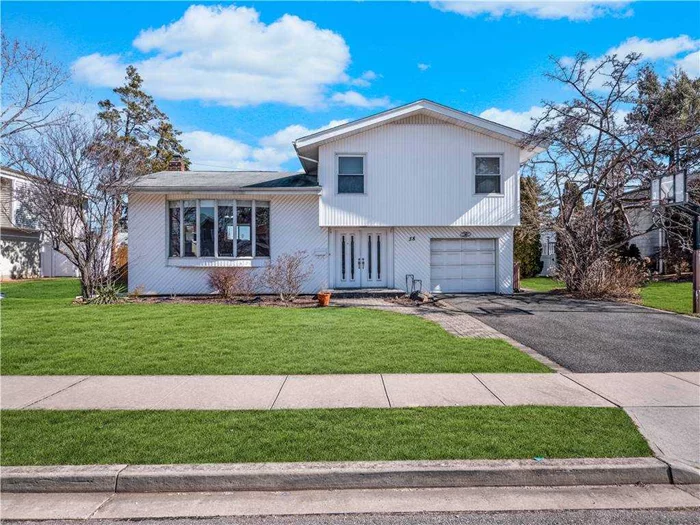 Beautiful bright 4 bedroom 1.5 bath Split located mid-block on a quiet Street. Featuring an open living and dining area with wood floors throughout. Updated kitchen leads out through the sliding doors to an expansive deck and spacious backyard. Upper level includes 3 large bedrooms a full bath. Main and lower levels include your 4th bedroom/office, half bath, large family room, laundry and utilities. Attached single car garage is an added convenience. Close to highways and shops. Syosset SD.