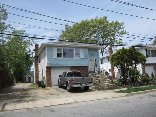 Hardwood Floors on Main Level, L-shaped Living Room Dining Room, Eat in Kitchen, Good Closet Space, Pull-down Stairs to Storage Attic. Lower Level Has 2 Additional Bedrooms and Full Bath. All This On An Oversized Lot. Near Theodore Roosevelt Park, LIRR Station