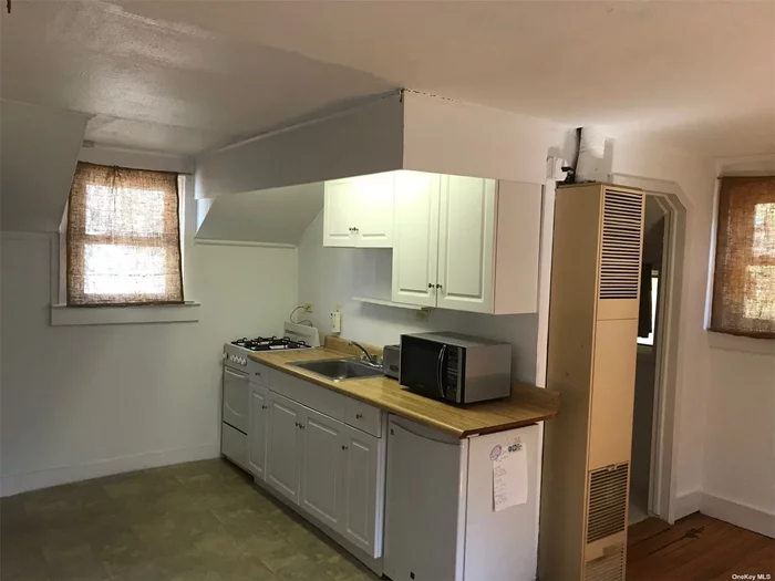 The perfect studio Apartment! Freshly painted with kitchen, bath and living and sleeping space. Includes driveway parking, gas, water and electric.