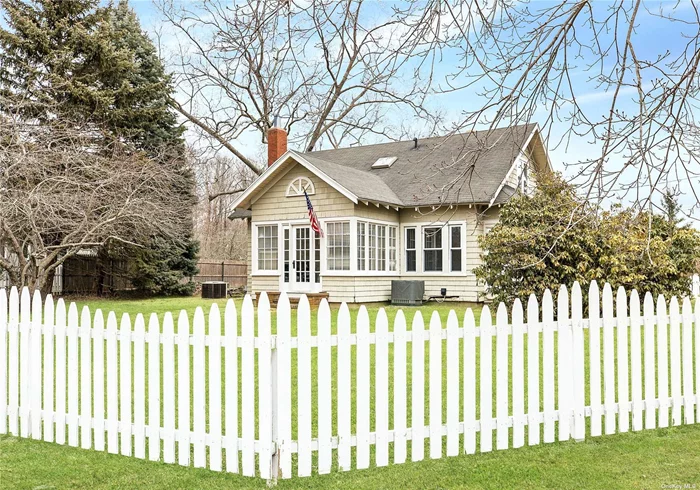 This traditional 1920&rsquo;s three-bedroom, two-bath Cape Cod is set behind a white picket fence at the head of Great Hog Neck, directly across the lane from five and a half acres of preserved Southold parkland. Gushing charm from every corner, it features cedar shingle siding, clawfoot cast iron tub, and six-burner dual-fuel Thermador chef&rsquo;s stove. The wide half-acre property includes lush gardens with pond, pergola, and the barn you have always dreamed of.