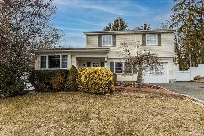 Space and privacy in a desirable Oyster Bay community. Stepping into this Colonial, the foyer with storage welcomes you. To the left, a spacious, light-filled living room features high ceilings and hardwood flooring. A separate den with a floor-to-ceiling brick fireplace and exposed wood beams offers a cozy space for relaxation. Walk back to the eat-in kitchen, where you will enjoy prepping meals with stainless steel appliances. The kitchen extends to the laundry room, conveniently located on the main level, which features additional cabinetry for extra storage. A formal dining room offers space for dinner parties. Upstairs, generous sized-bedrooms are filled with natural light. The updated bathroom feels like a spa with a walk-in shower and soaking tub. Outside, the level, fenced-in backyard is easy to maintain and ideal for entertaining. Located in a historic town close to area restaurants, shopping, beaches, parks, and more. Schedule your showing today!