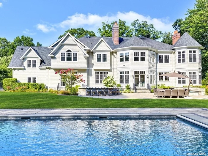 Everything you could ask for! This classic yet modern colonial epitomizes the Hamptons style w/opulent grounds & open lawns. The perfect setting for its 3-year old in-ground heated saltwater pool w/stunning waterfall hot tub, 2 patios, fabulous outdoor kitchen & built-in fire pit. Perfect for summer gatherings. A mahogany covered front wrap-around porch leads to a double height entry foyer which looks out onto the country club yard. No detail is overlooked in this magnificent home offering 10&rsquo; ceilings on the first floor, 9&rsquo; ceilings on the 2nd floor, generous entertaining spaces, butler&rsquo;s pantry w/wet bar, custom detailed mill work, huge kitchen-den great room w/22&rsquo; ceilings, turreted breakfast area, 2nd den w/French doors & fireplace, main level bedroom/bath, and luxurious master suite. Radiant heated floor in master bath. Low taxes. Just painted inside & out. 3000-sq ft. basement w/10&rsquo; ceilings. Tucked away at the end of a quiet cul-de-sac in the village of Muttontown.