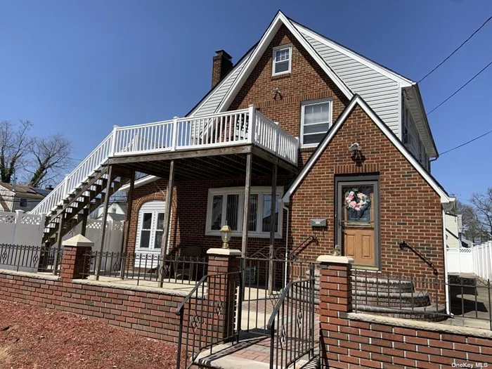 Come home to this Tudor-style brick colonial and relax in the enclosed tile-floored sunroom! Features spacious rooms and hardwood floors throughout with classic wide mouldings around base, windows and doors. 2nd floor deck has staircase leading to maintenance-free fenced yard with concrete/brick patio. A must see!